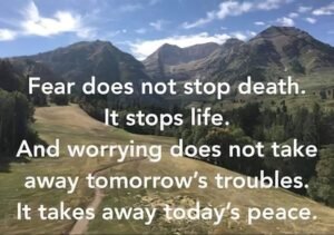 Scenic landscape with a motivational quote about fear and worry